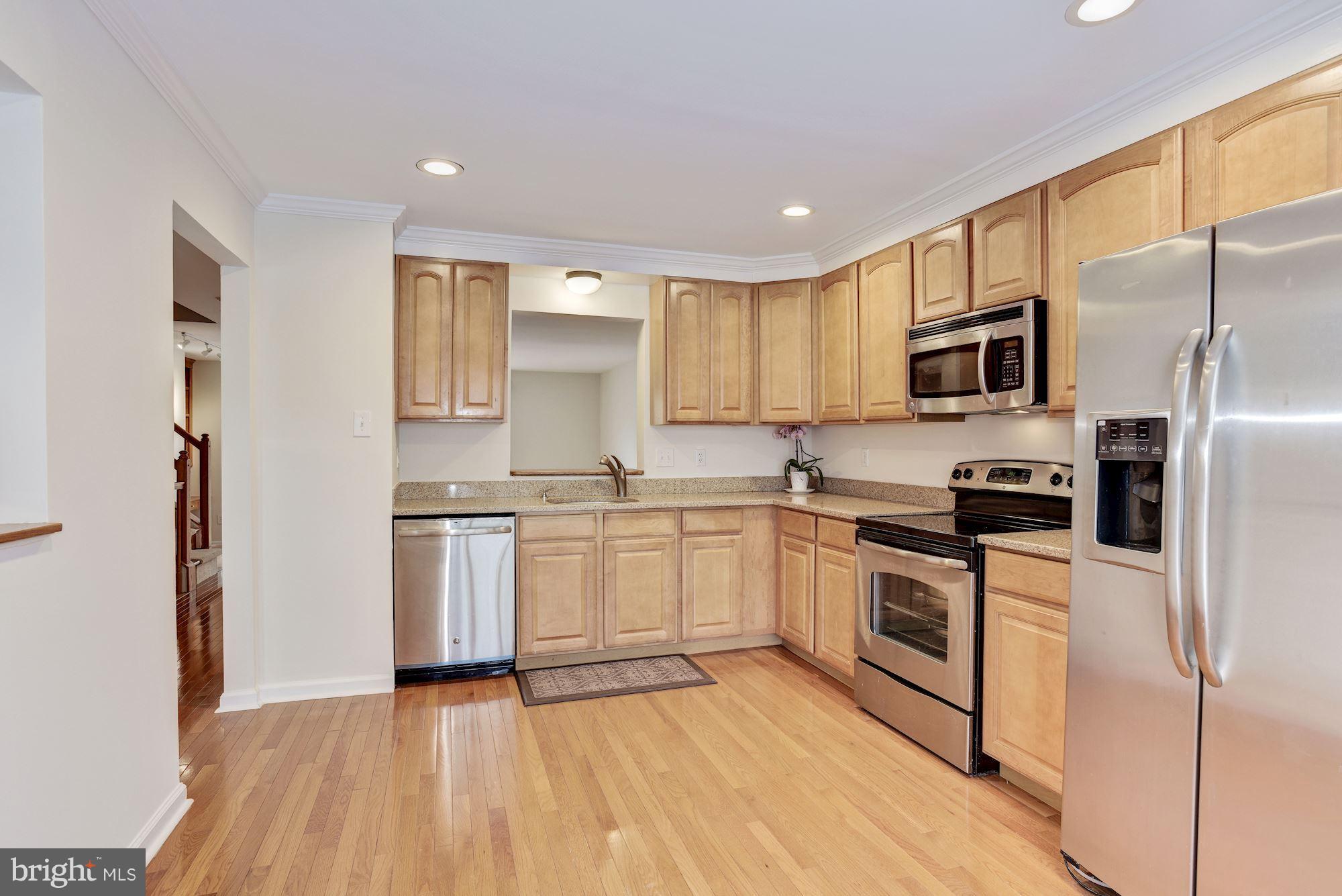 5133 Columbia Road, Unit 1595 Columbia, MD 21044 - Photo 4 of 30 a kitchen with a refrigerator stove and microwave
