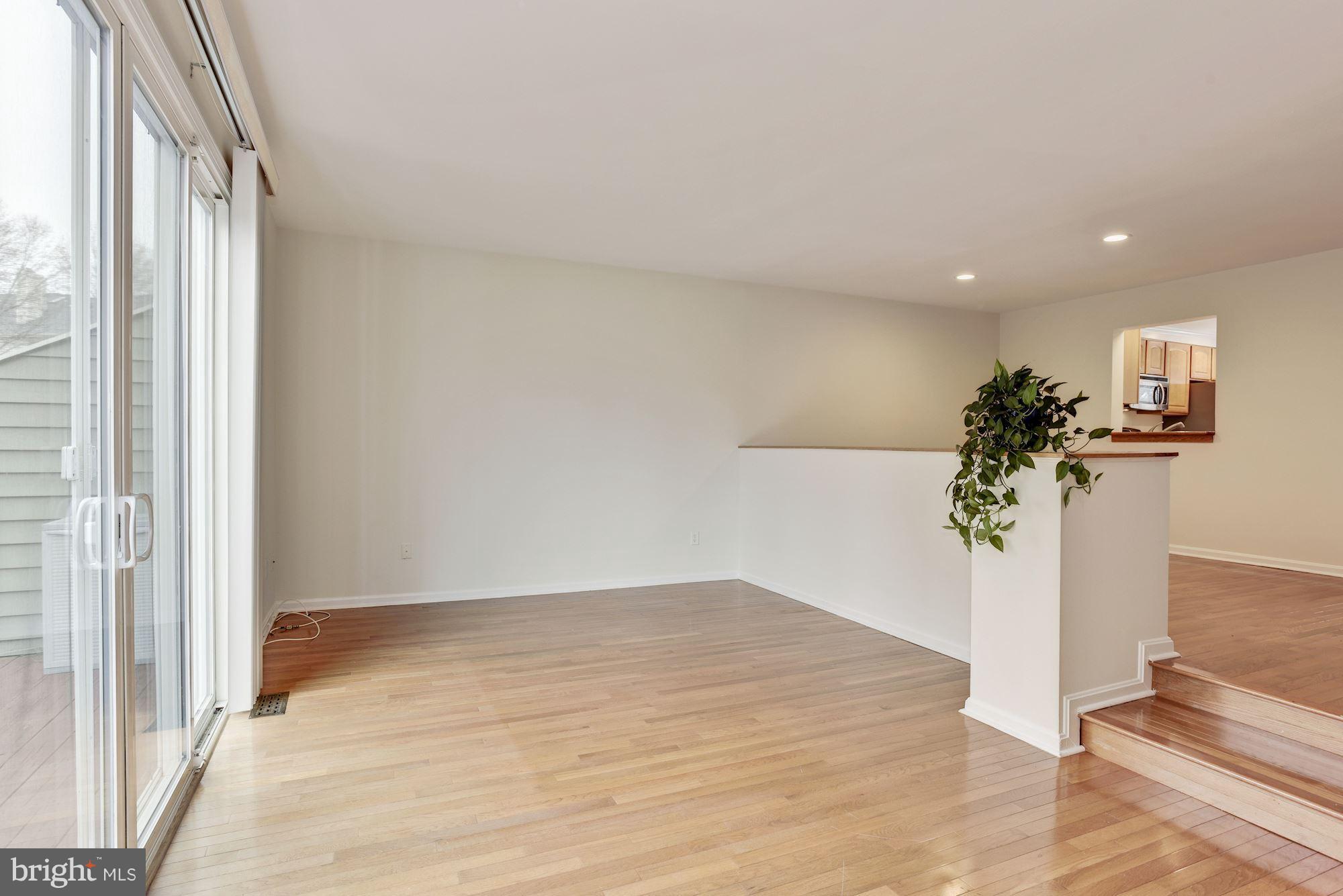 5133 Columbia Road, Unit 1595 Columbia, MD 21044 - Photo 8 of 30 a view of a room with wooden floor and a potted plant