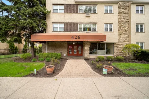 a front view of a building with garden