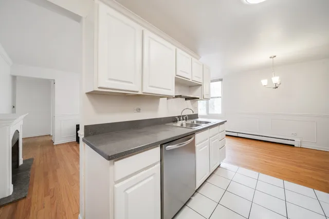a kitchen with granite countertop a sink and a stove