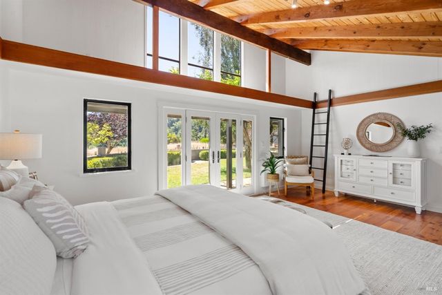 a bed sitting in a bedroom next to a window