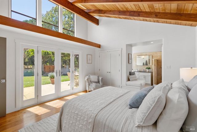 a bedroom with a large bed and a large window