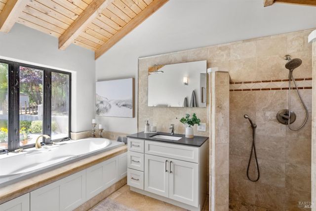 a bathroom with a double vanity sink mirror and shower