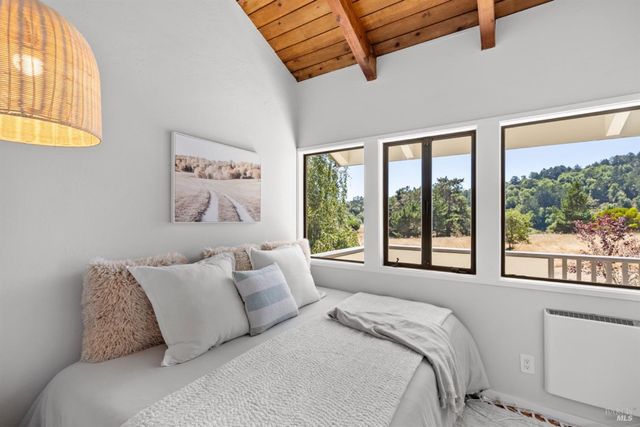 a bed sitting in a bedroom next to a window