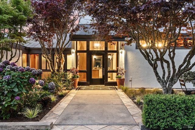 a front view of a house with a garden