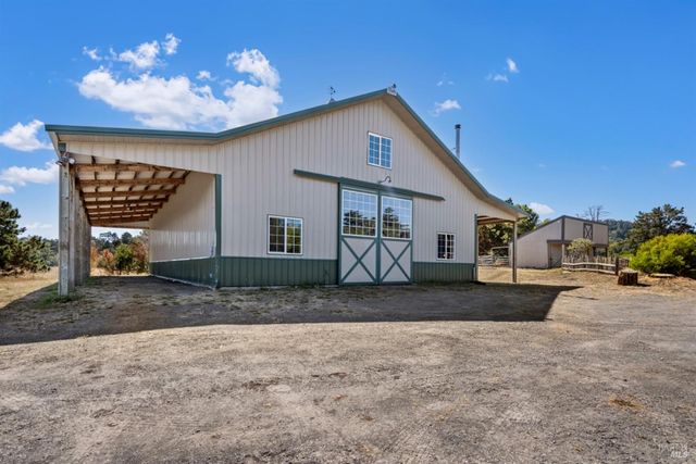a view of a house with a yard and a garage