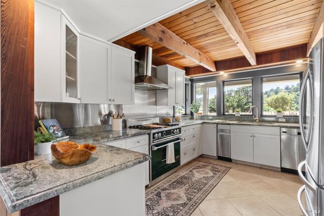 a kitchen with a stove sink and cabinets