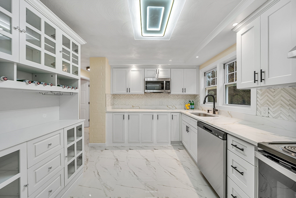 9 Donna Road Chelmsford, MA 01824 - Photo 8 of 37 a kitchen with cabinets and window