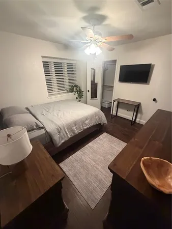 a bedroom with a bed window and couch