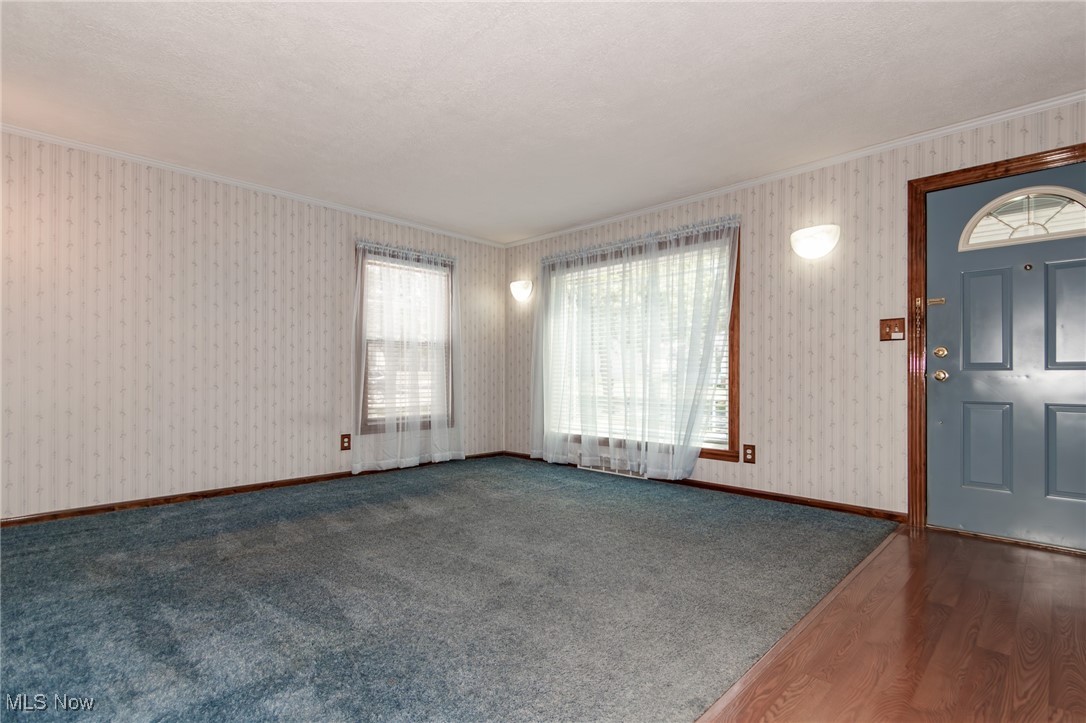 5223 Edenhurst Road Cleveland, OH 44124 - Photo 2 of 50 Foyer entrance with crown molding, wood finished floors, and wallpapered walls