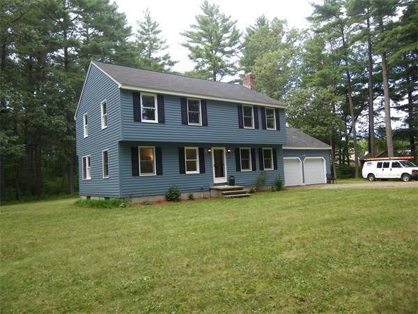 127 Patten Road Tewksbury, MA 01876 - Photo 14 of 16 a front view of a house with a garden