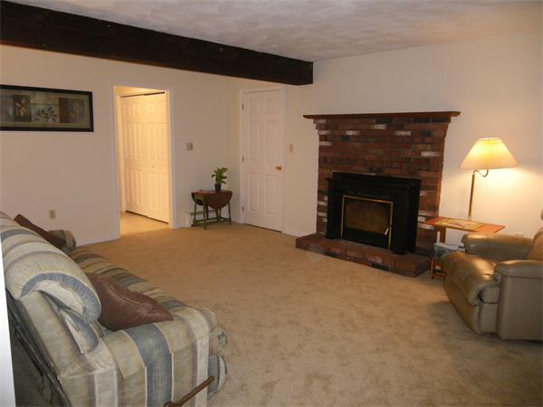 127 Patten Road Tewksbury, MA 01876 - Photo 7 of 16 a bedroom with a bed and a fireplace