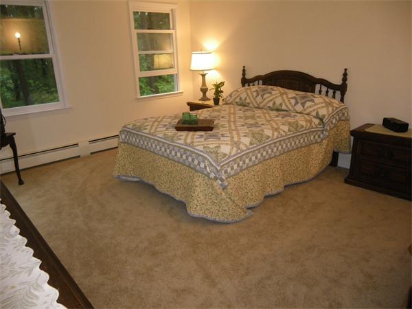 127 Patten Road Tewksbury, MA 01876 - Photo 10 of 16 a bed sitting in a bedroom next to a window