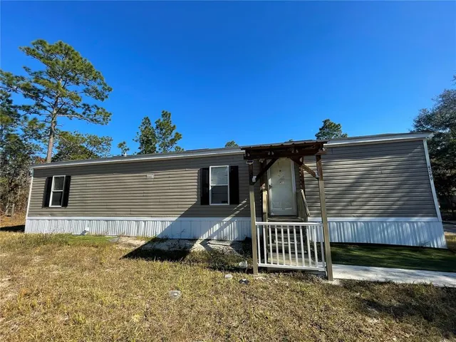 a view of a house with wooden fence