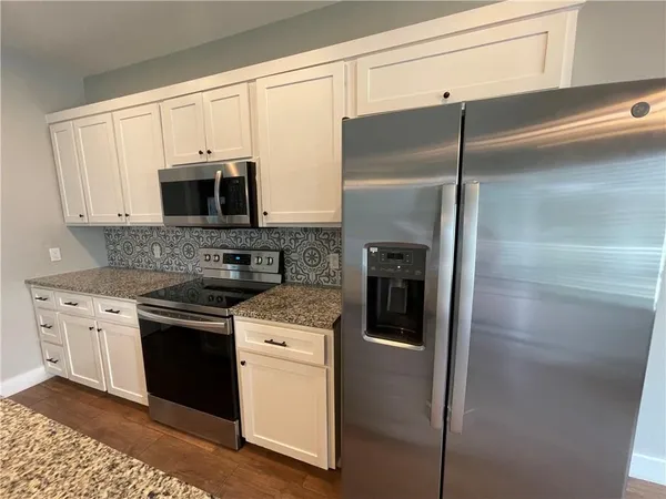 a kitchen with a refrigerator stove and microwave