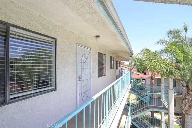 a view of balcony with wooden floor and fence