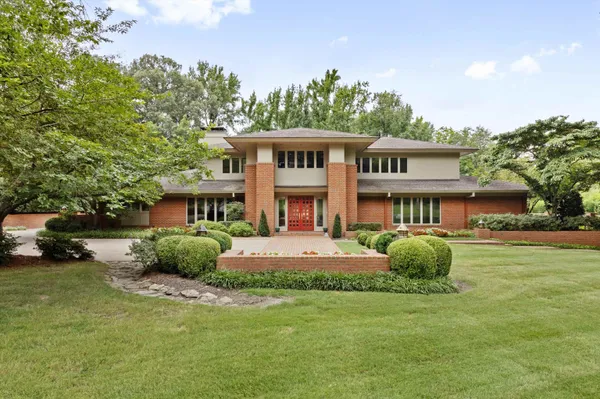 a front view of a house with a garden