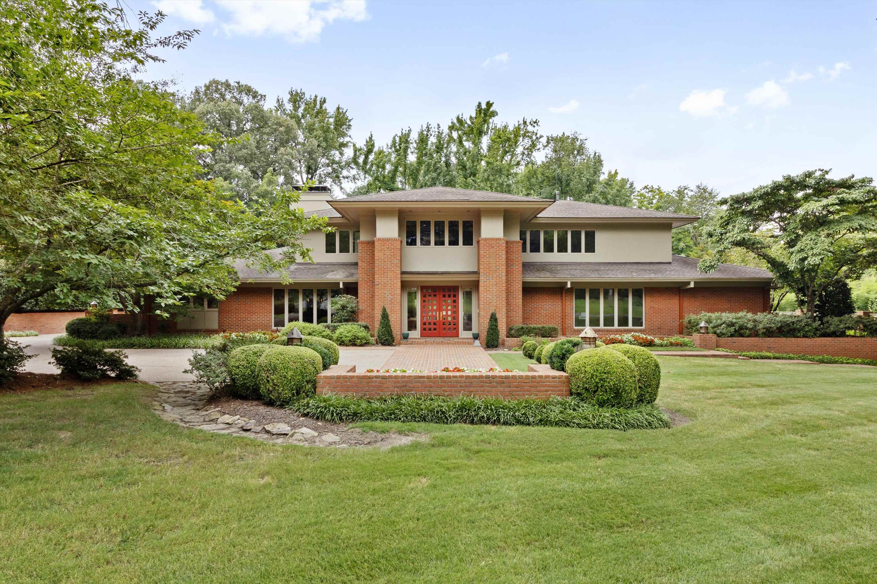 a front view of a house with a garden