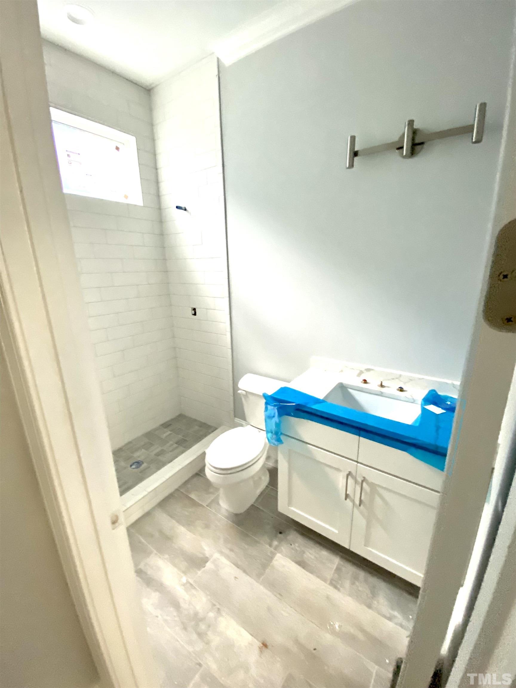 308.5 Furches Street Raleigh, NC 27607 - Photo 14 of 19 a bathroom with a sink a toilet and shower