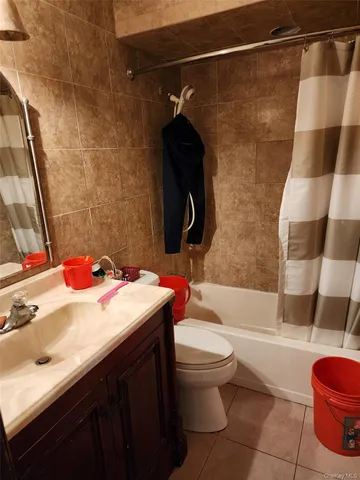 a bathroom with a sink vanity mirror and toilet