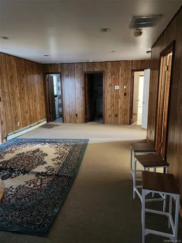 a view of hallway with wooden floor