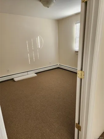 a view of a room with rack on the wall and a window