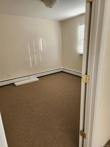 a view of a room with rack on the wall and a window