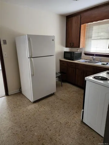 a living room with furniture a window and appliances