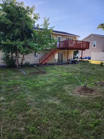 a backyard of a house with table and chairs