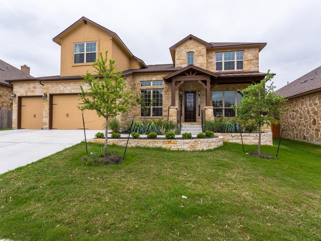 a front view of a house with a yard table and chairs