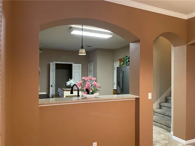 a view of a dining room with furniture and chandelier
