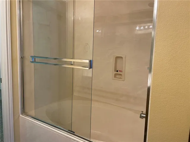 a bathroom with a glass shower door