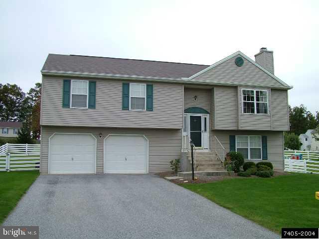 235 Pond Road Felton, PA 17322 - Photo 1 of 2 a front view of a house with a yard and garage