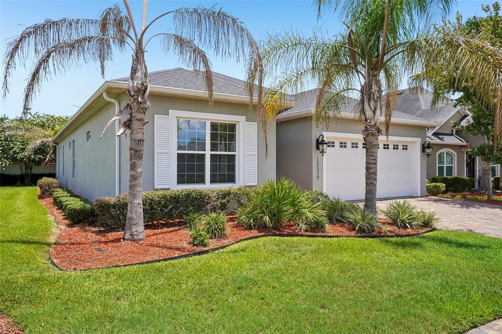 10339 Addison Shore Way Oxford, FL 34484 - Photo 23 of 54 a front view of a house with garden