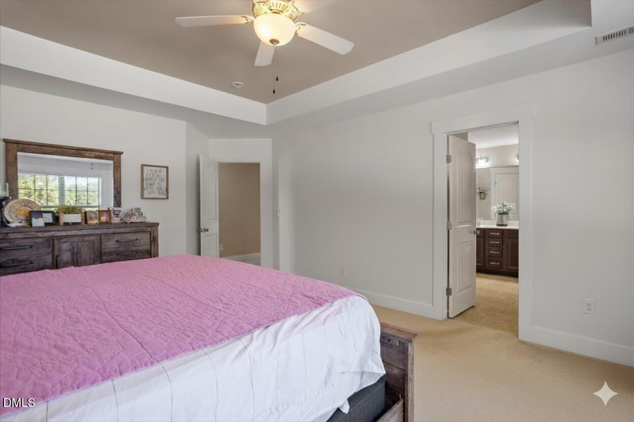 4222 Vineyard Ridge Drive Zebulon, NC 27597 - Photo 14 of 39 a bed room with a bed and dresser