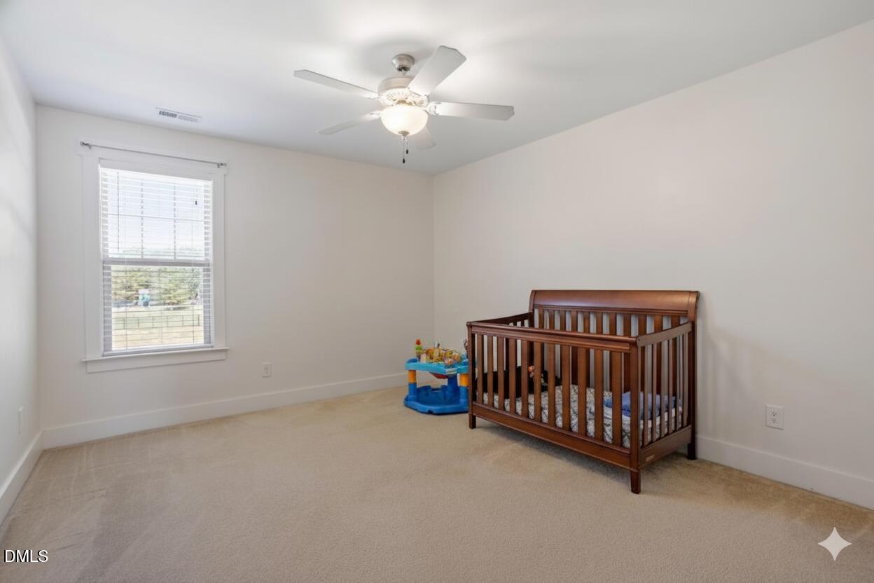 4222 Vineyard Ridge Drive Zebulon, NC 27597 - Photo 19 of 39 a bedroom with furniture and window