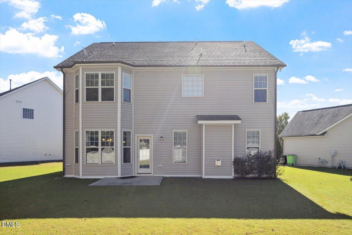 4222 Vineyard Ridge Drive Zebulon, NC 27597 - Photo 27 of 39 a view of a house with a backyard
