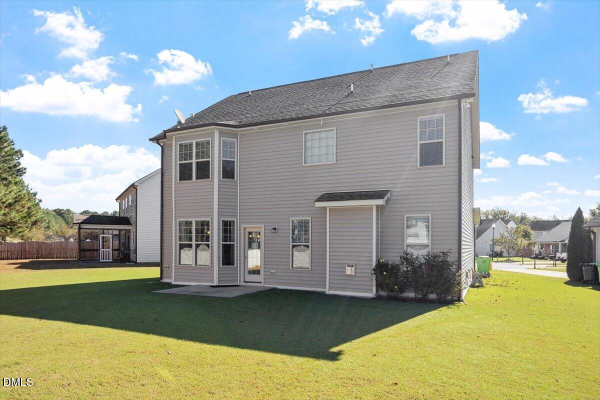 4222 Vineyard Ridge Drive Zebulon, NC 27597 - Photo 28 of 39 a front view of a house with a garden