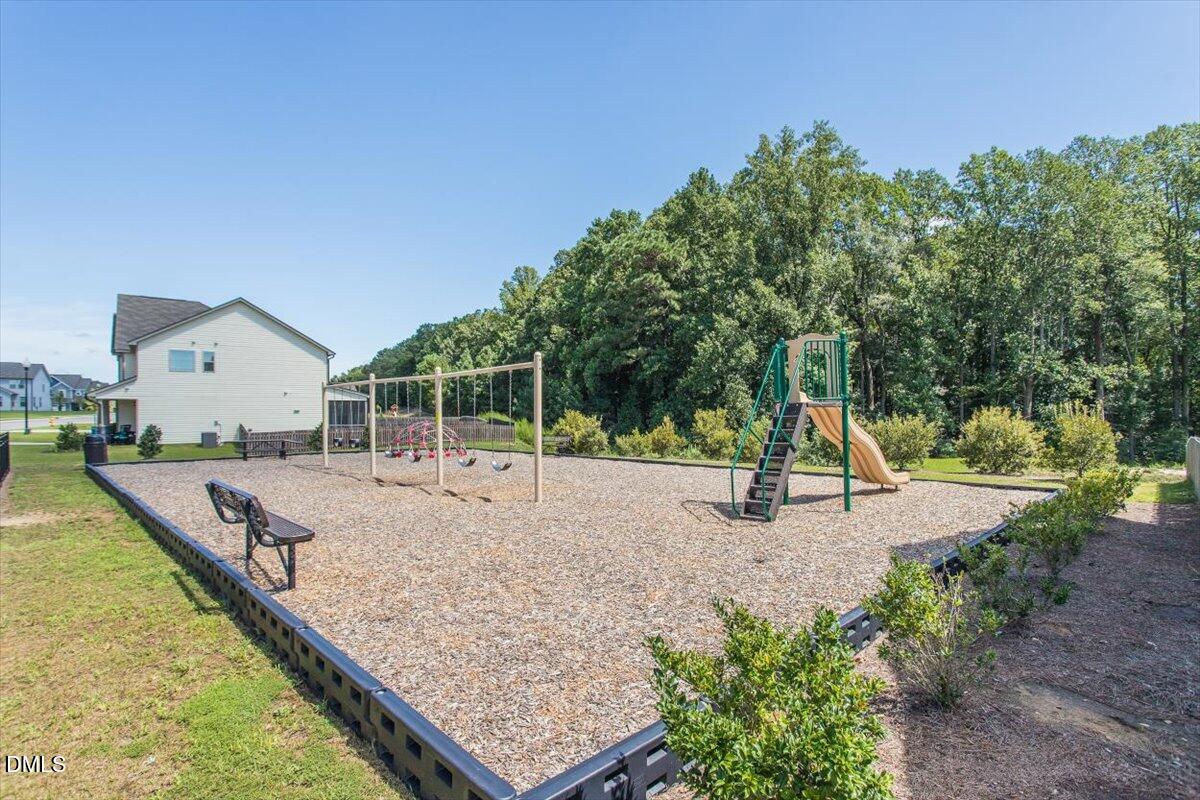 4222 Vineyard Ridge Drive Zebulon, NC 27597 - Photo 34 of 39 a view of a house with swimming pool and sitting area
