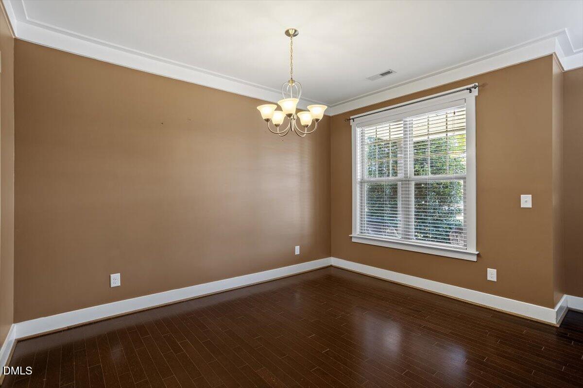 4222 Vineyard Ridge Drive Zebulon, NC 27597 - Photo 4 of 39 a view of wooden floor and chandelier in a room
