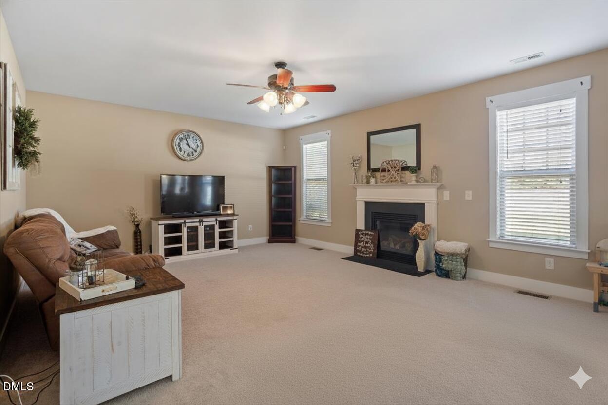 4222 Vineyard Ridge Drive Zebulon, NC 27597 - Photo 6 of 39 a living room with furniture and a fireplace