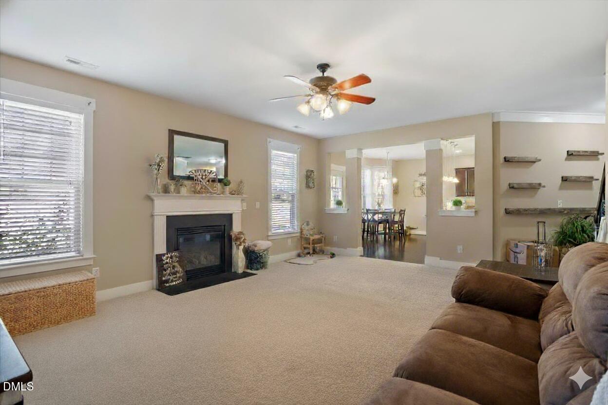 4222 Vineyard Ridge Drive Zebulon, NC 27597 - Photo 7 of 39 a living room with furniture a fireplace and a window
