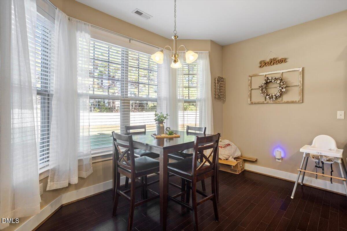4222 Vineyard Ridge Drive Zebulon, NC 27597 - Photo 9 of 39 a view of a dining room with furniture and wooden floor