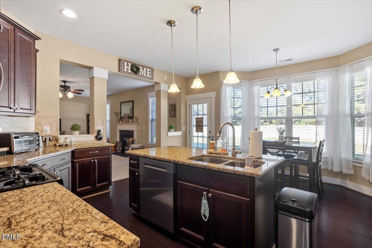 4222 Vineyard Ridge Drive Zebulon, NC 27597 - Photo 10 of 39 a kitchen with stainless steel appliances granite countertop a sink stove and refrigerator