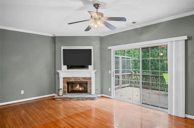 a view of an empty room with a fireplace and a window