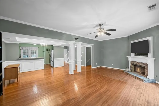 a view of an empty room with a fireplace and a window
