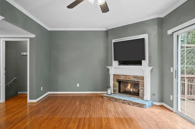 an empty room with fireplace and wooden floor