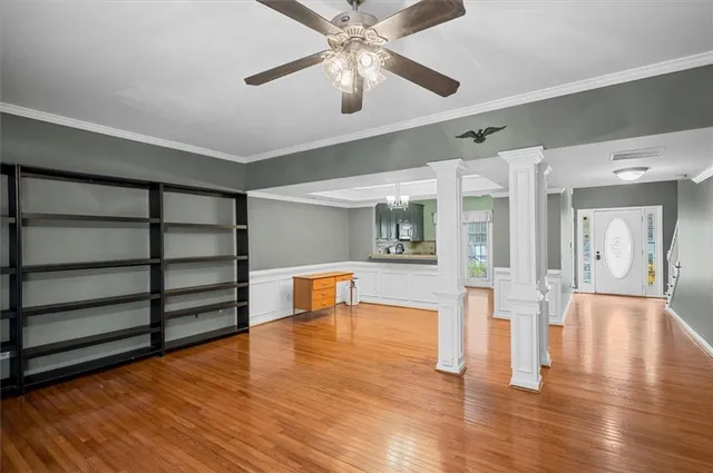 a view of empty room with wooden floor