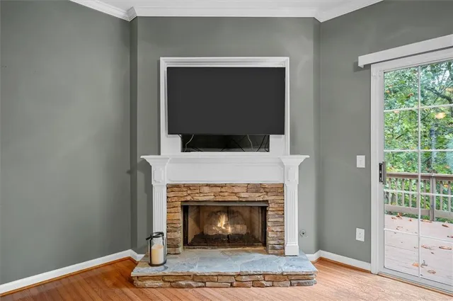 a living room with a fireplace and a wooden floor