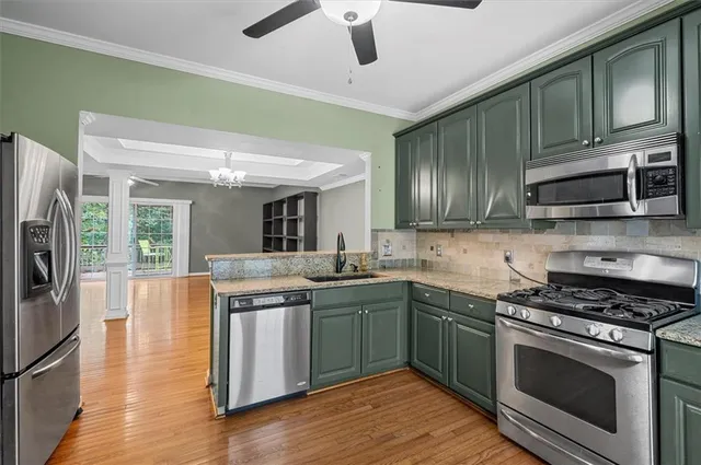 a kitchen with stainless steel appliances granite countertop a stove and a sink